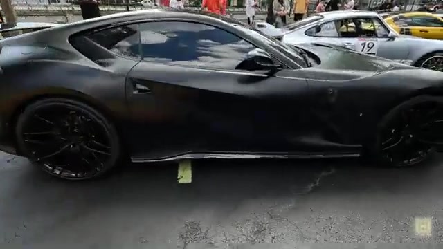 Crowd gathering around Gumball 3000 rally cars